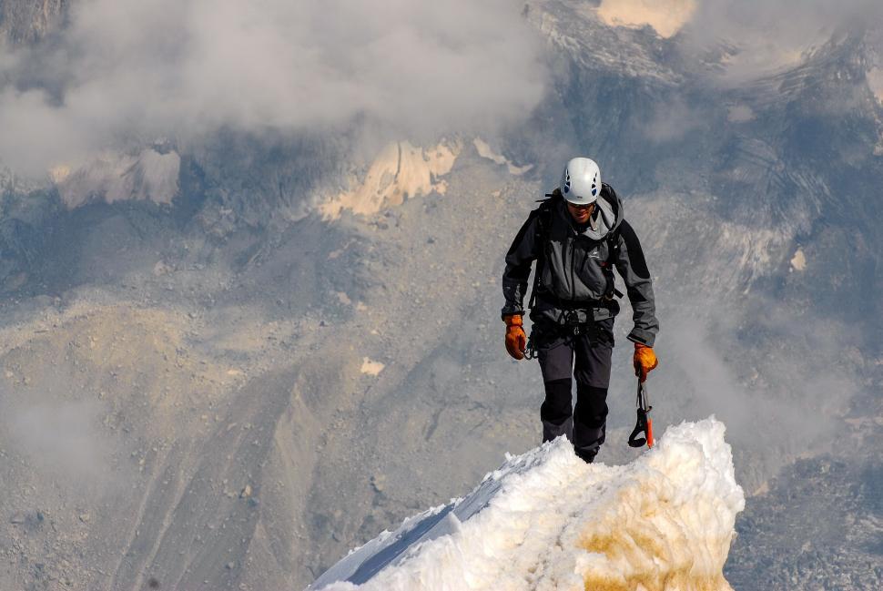Free Image of Man Standing on Snow Covered Mountain Top 