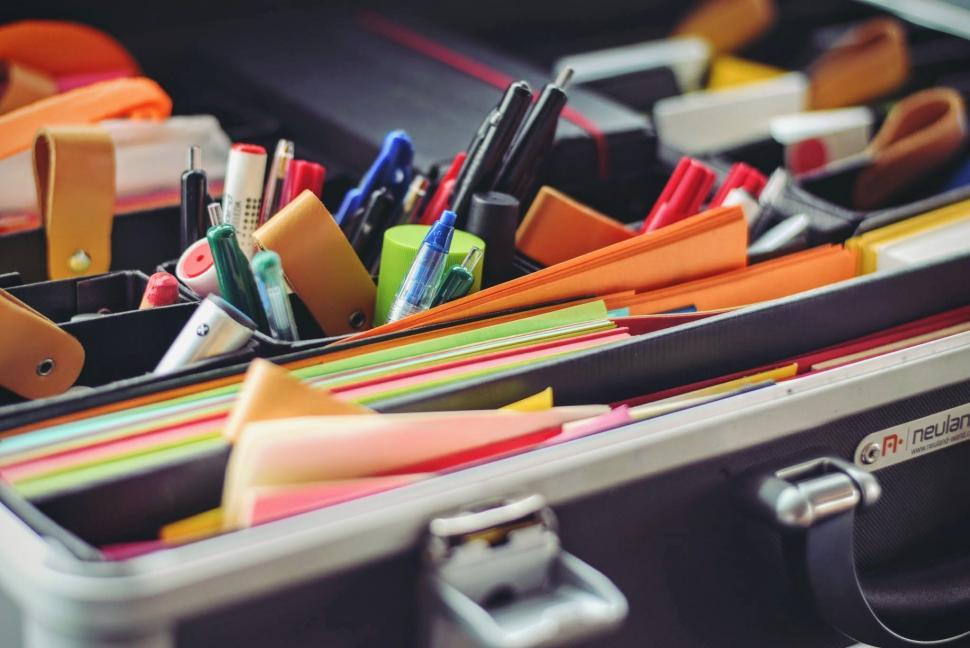 Free Image of Suitcase Filled With Different Colored Pens and Pencils 
