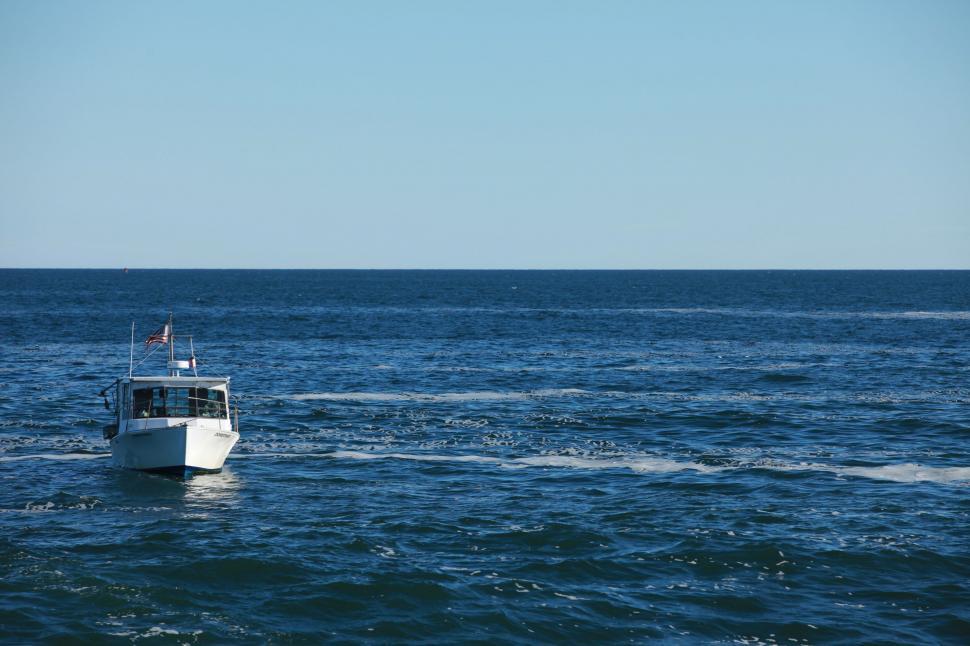 Free Image of White Boat Sailing in Open Ocean 