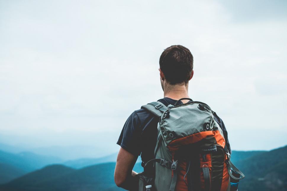 Free Image of Man With Backpack Looking at the Mountains 