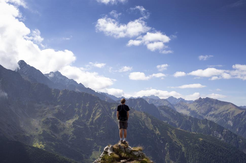 Free Image of Person Standing on Top of a Mountain 