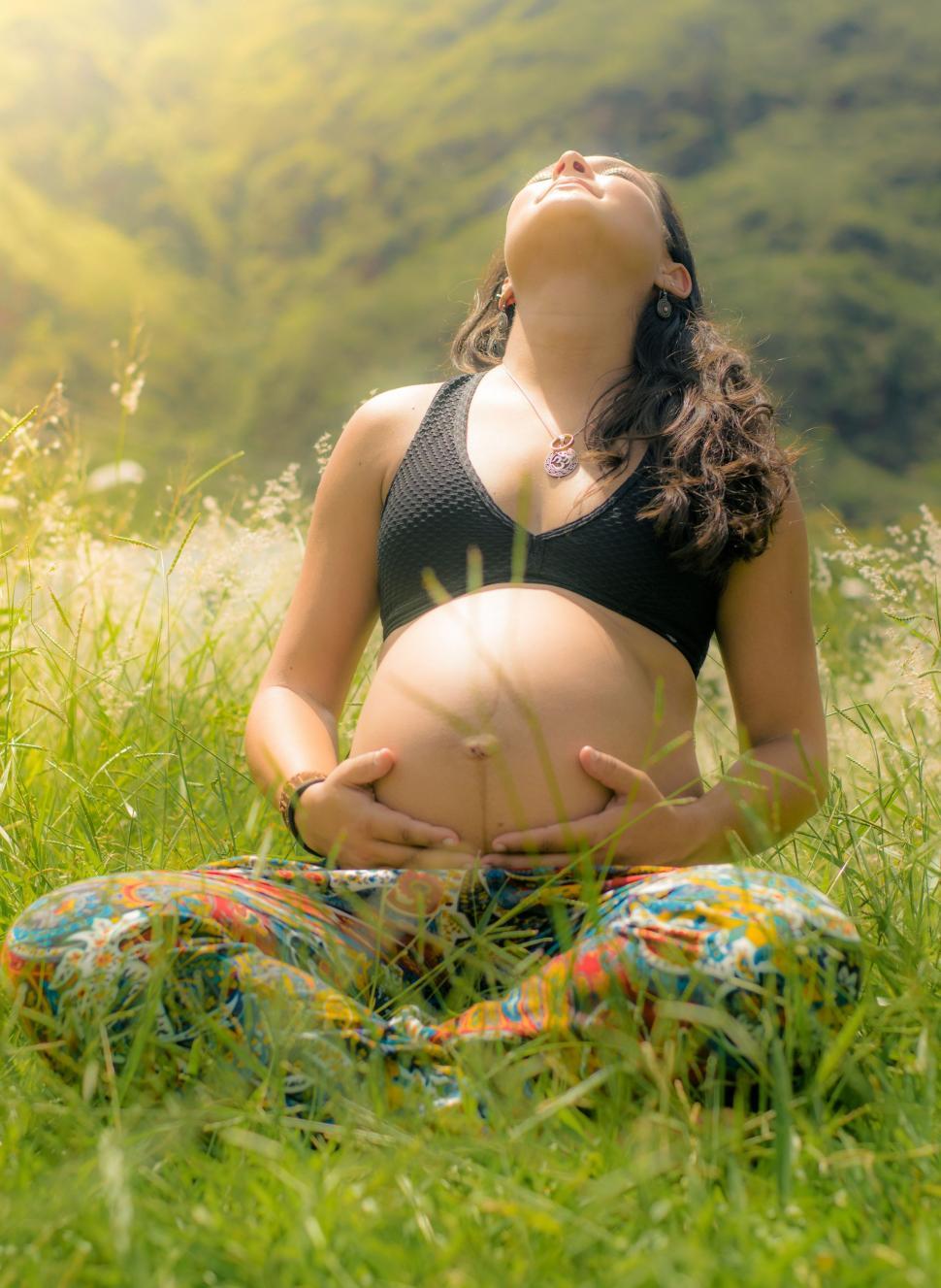 Free Image of Pregnant Woman Sitting in the Grass 