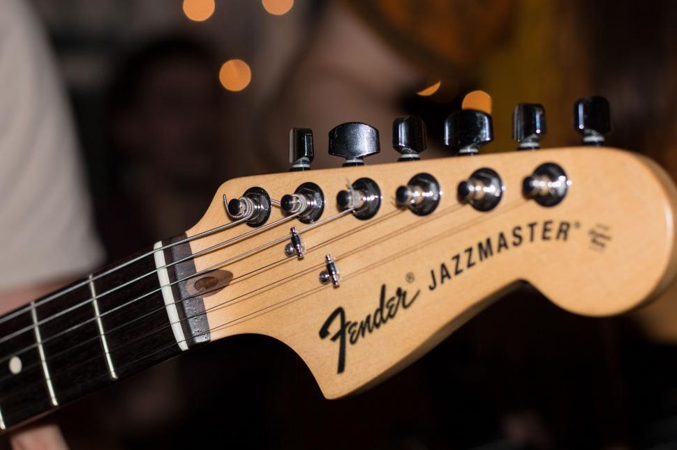 Free Image of Guitar Close-Up With Person in Background 