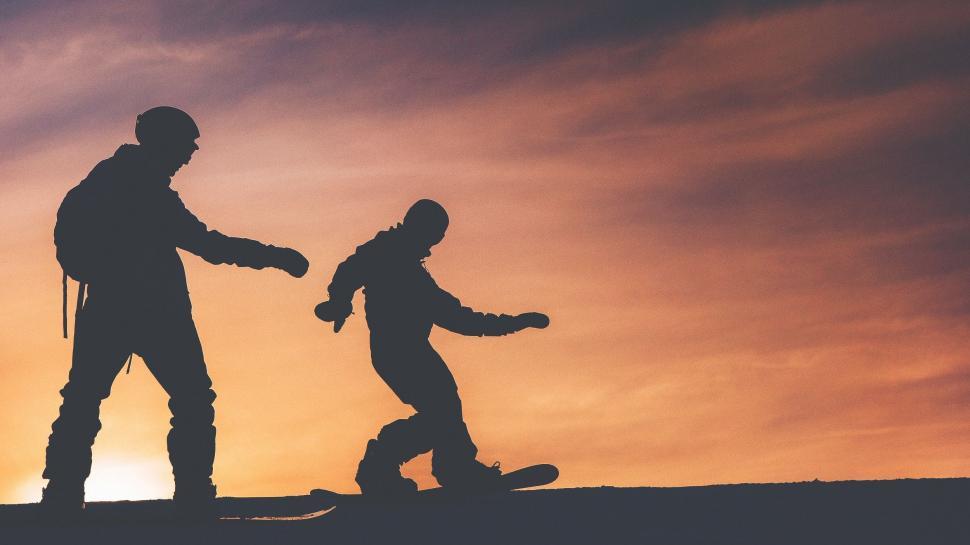 Free Image of Couple Standing on Top of Snowboard 