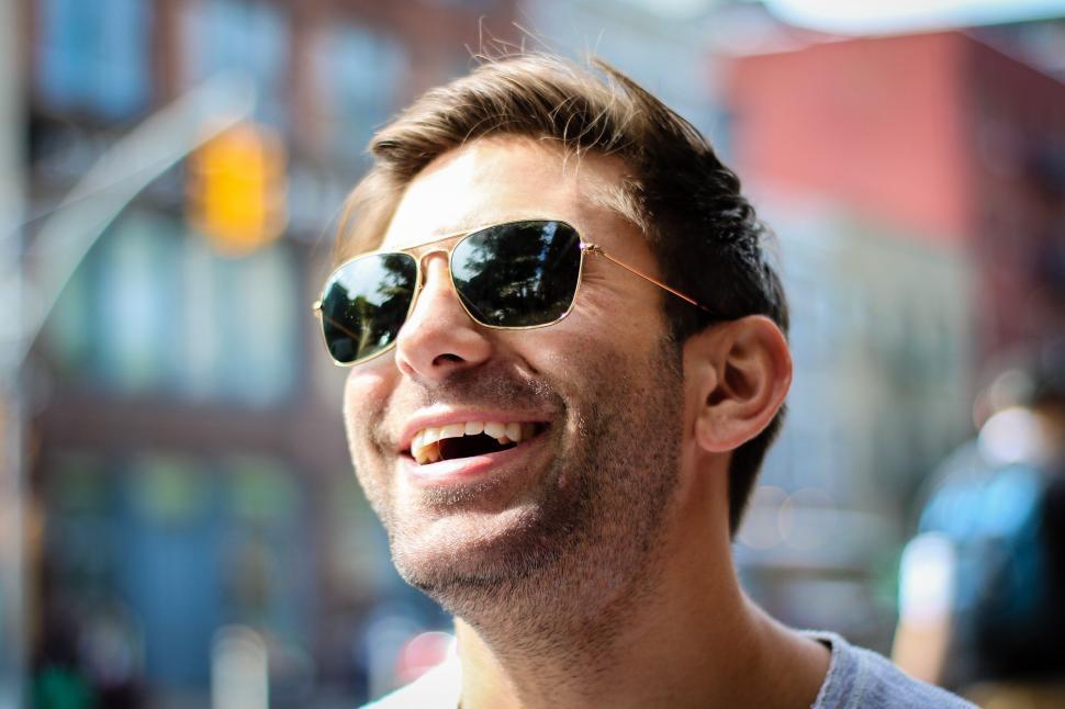 Free Image of Smiling Man in Sunglasses on City Street 
