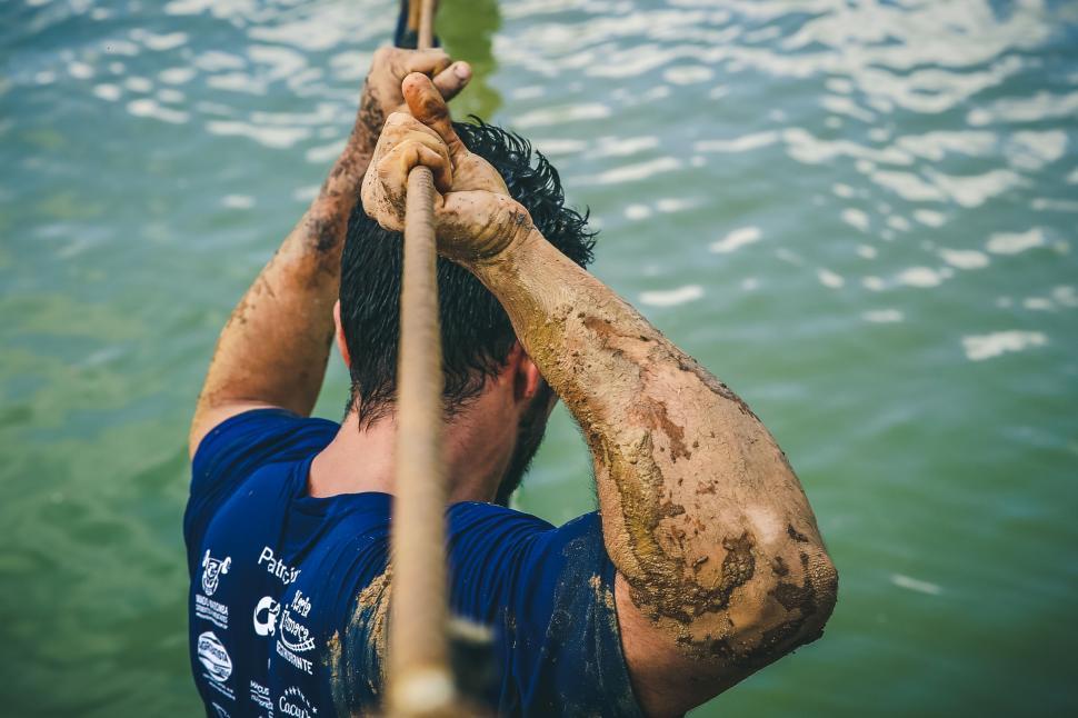 Free Image of Man With Mud on His Face Holding a Paddle 