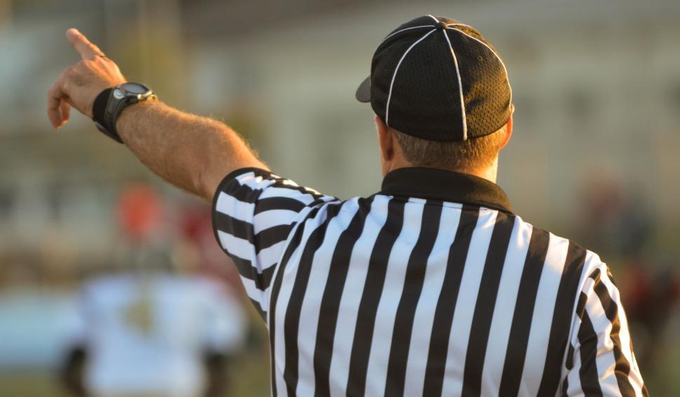 Free Image of Referee Pointing to the Side of the Field 
