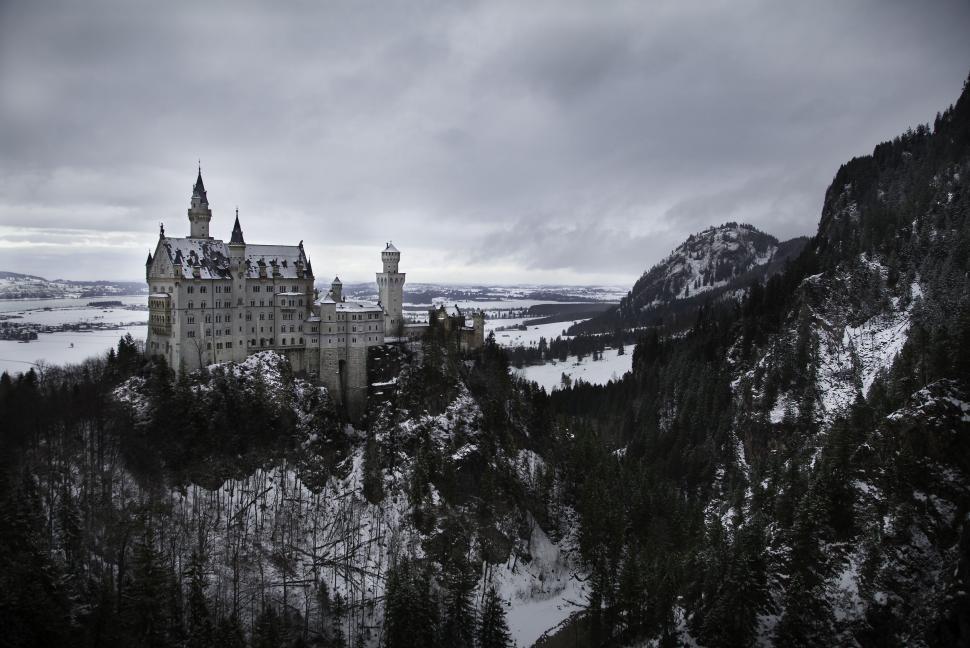 Free Image of Castle Perched on Snowy Mountain Peak 