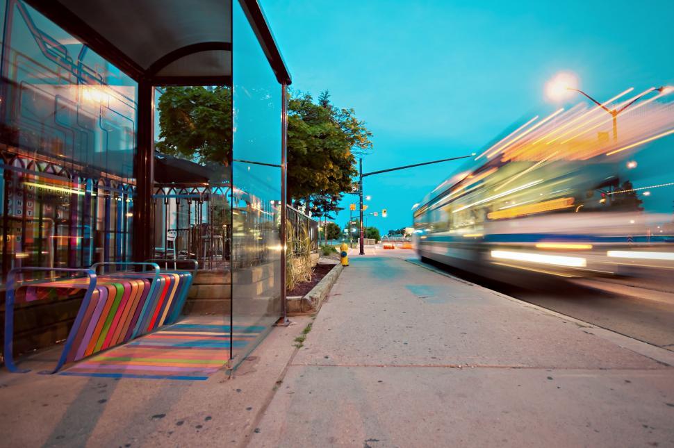 Free Image of Blurry Photo of Bus Passing by Bus Stop 