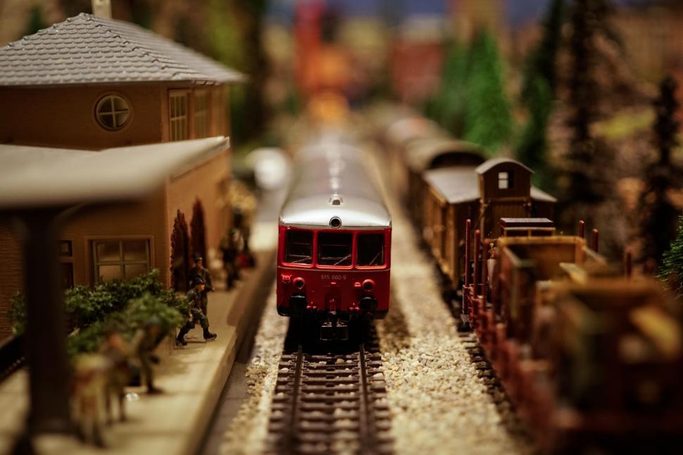 Free Image of Red Train Passing Through Forest on Train Tracks 