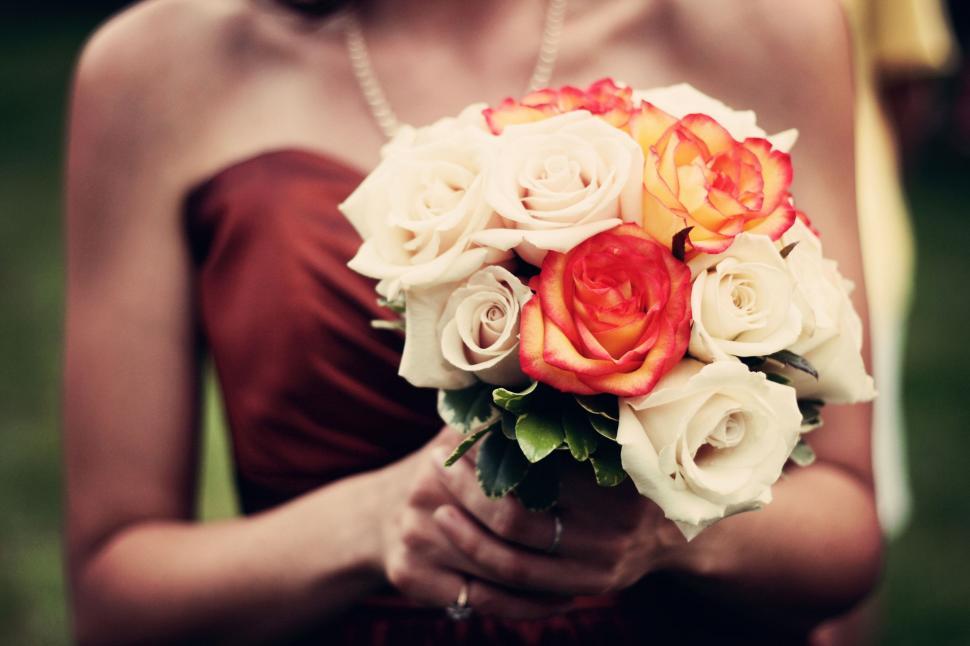 Free Image of Woman in Red Dress Holding Bouquet of Flowers 