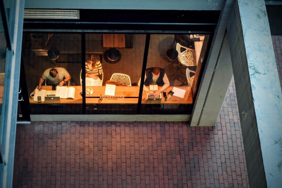 Free Image of Group of People Sitting at a Table by Window 