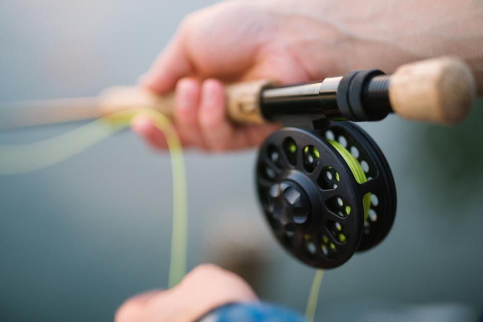 Free Image of A Person Holding a Fishing Rod and Fishing Reel 