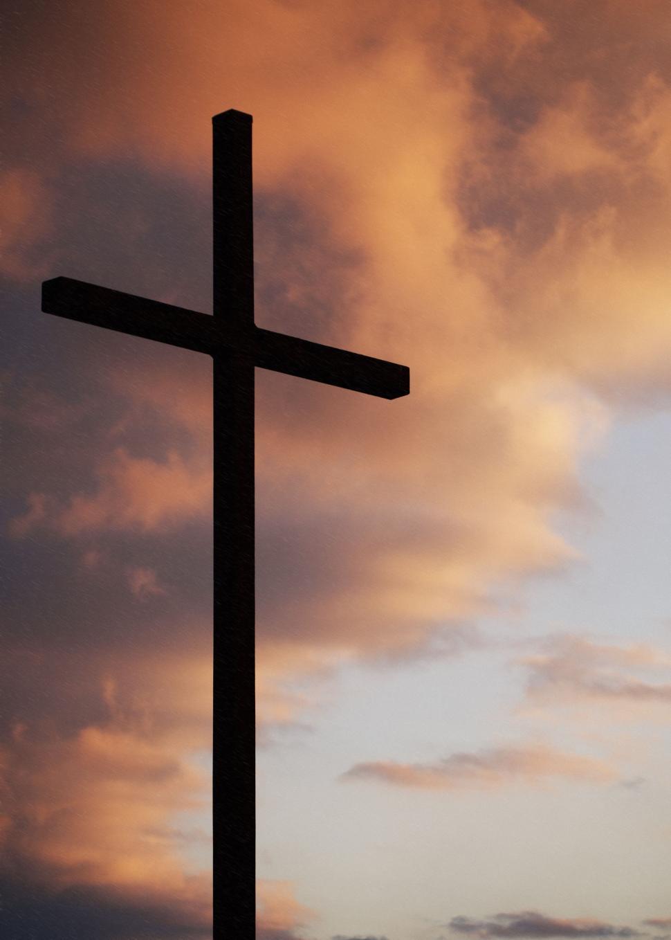 Free Image of Cross on Top of a Hill Under Cloudy Sky 