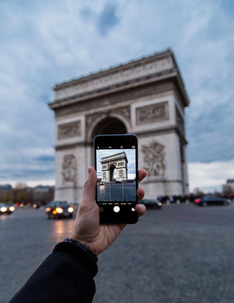 Free Image of Person Taking Picture of the Arc De Triomphe 