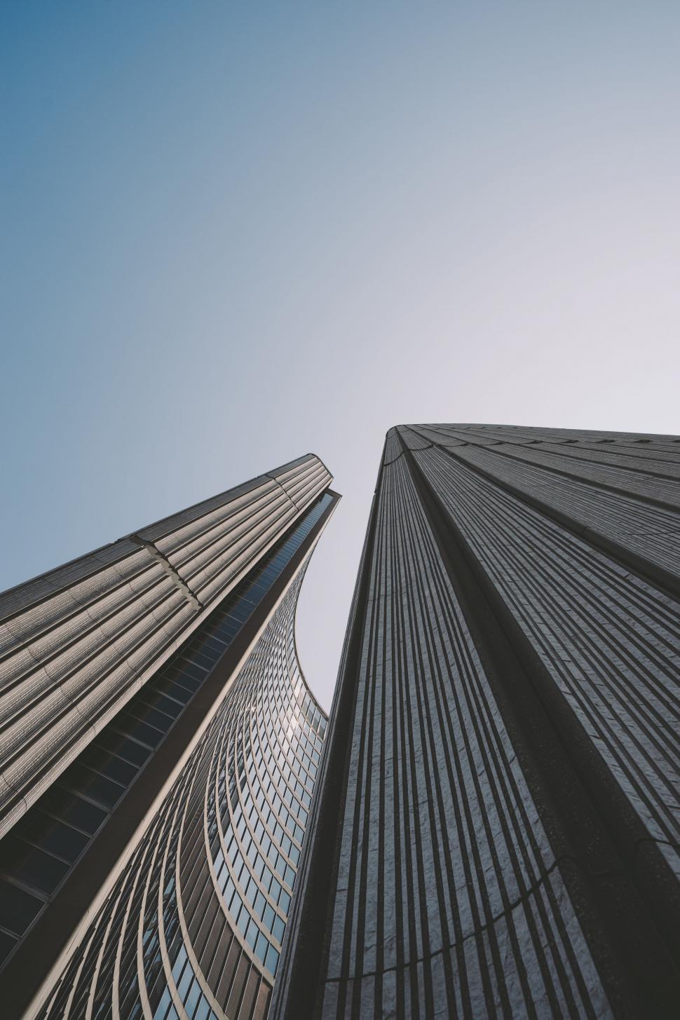 Free Image of Looking Up at Two Tall Buildings in a City 