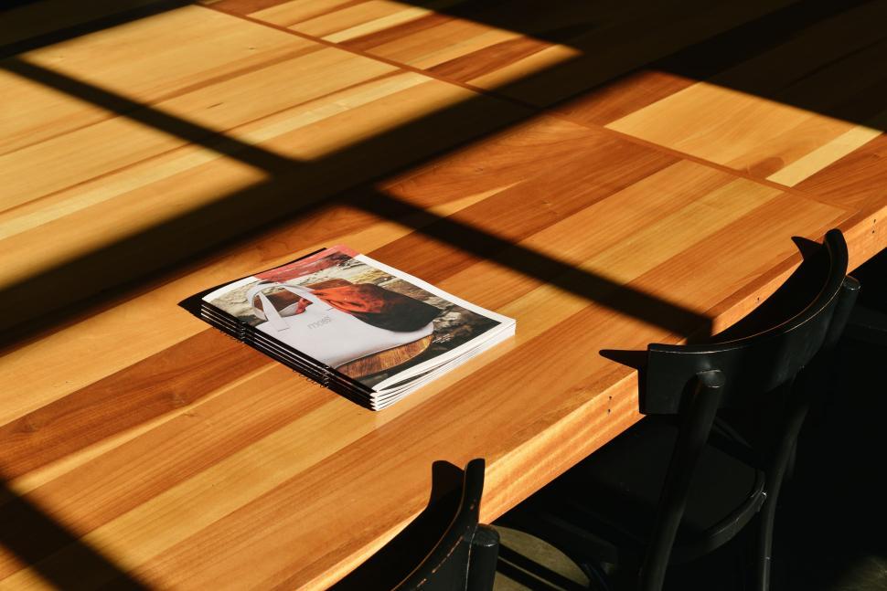 Free Image of Magazine on Wooden Table 