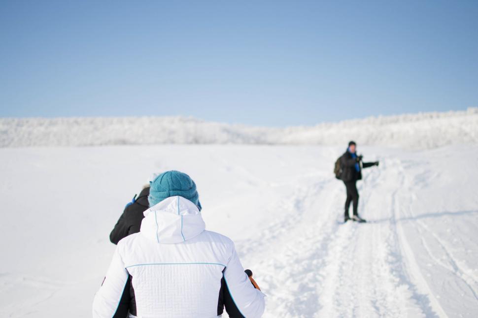 Free Image of Couple Skiing Down Snowy Slope 