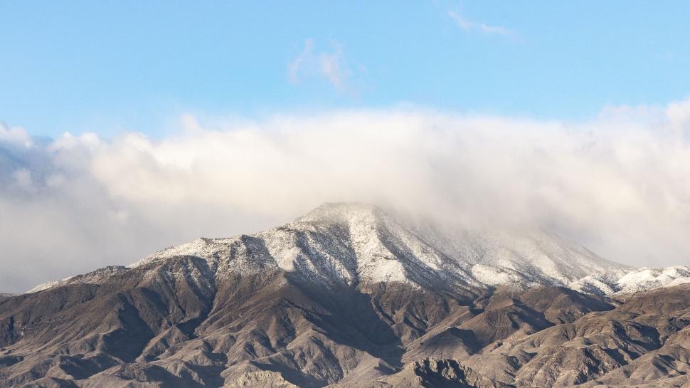 Free Image of Snow Covered Mountain Range Beneath Blue Sky 