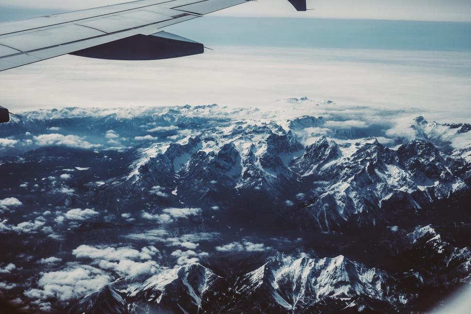 Free Image of Airplane Wing Flying Over Mountain Range 