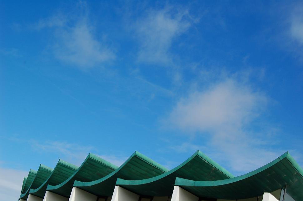 Free Image of Green and White Building Against Blue Sky 