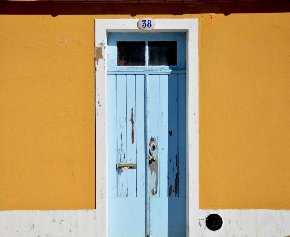 Free Image of Blue Door Against Yellow Wall 