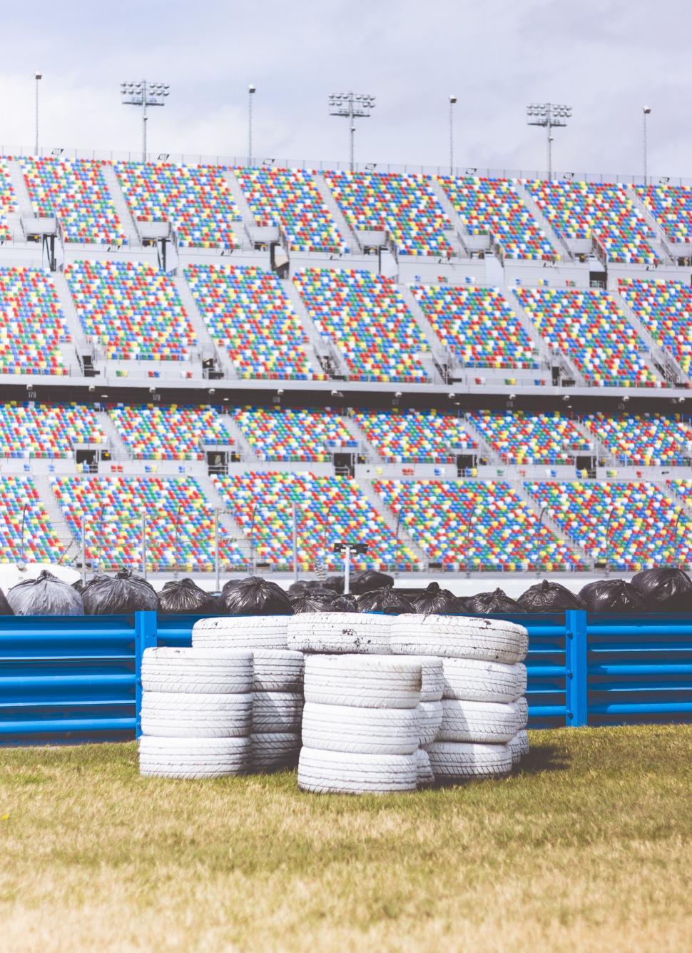 Free Image of White Tires in Front of Blue Fence 