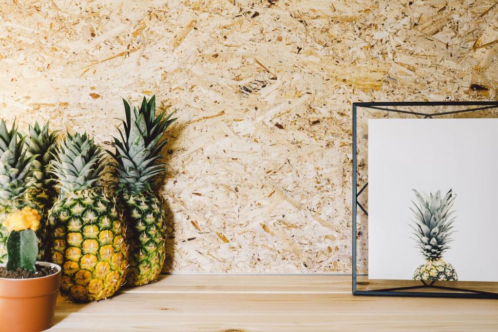 Free Image of Pineapple and Potted Plant on Table 