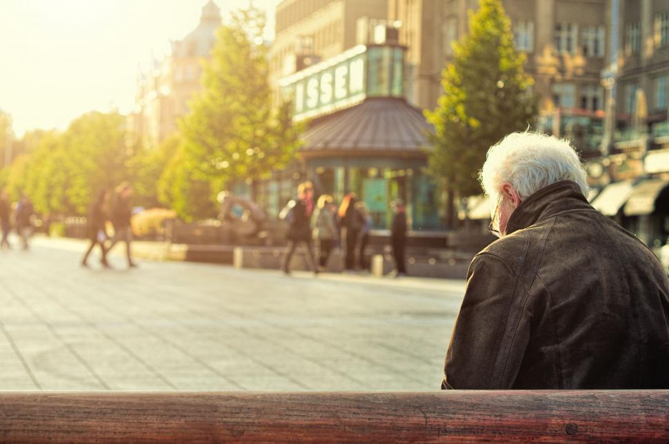 Free Image of Old Man Sitting on Bench in City 