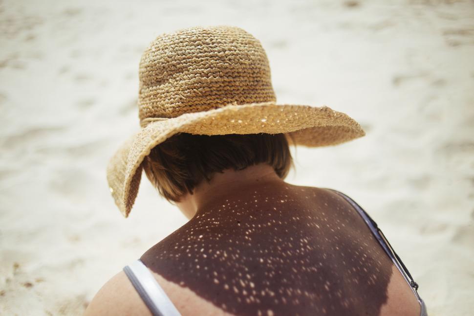 Free Image of Woman Wearing Hat on Beach 