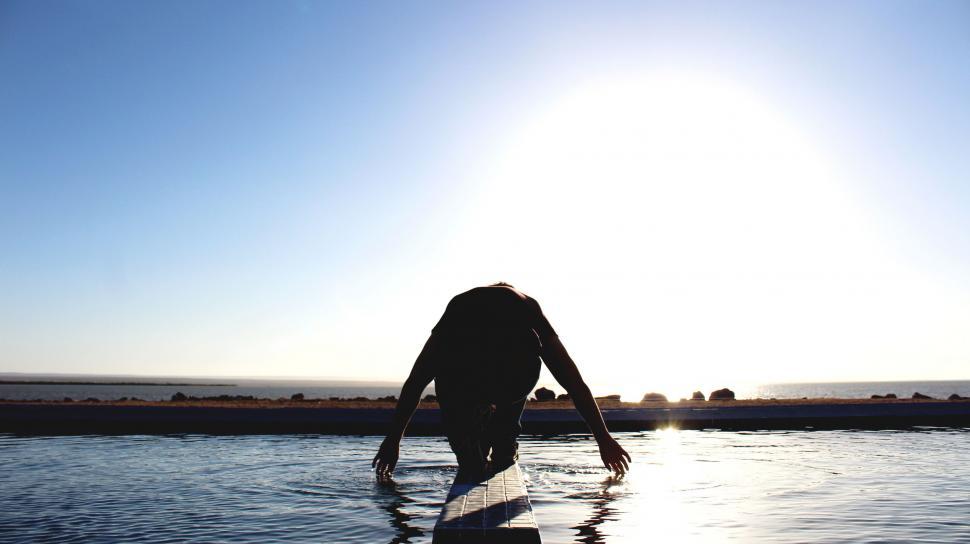 Free Image of Person Standing on Surfboard in Water 