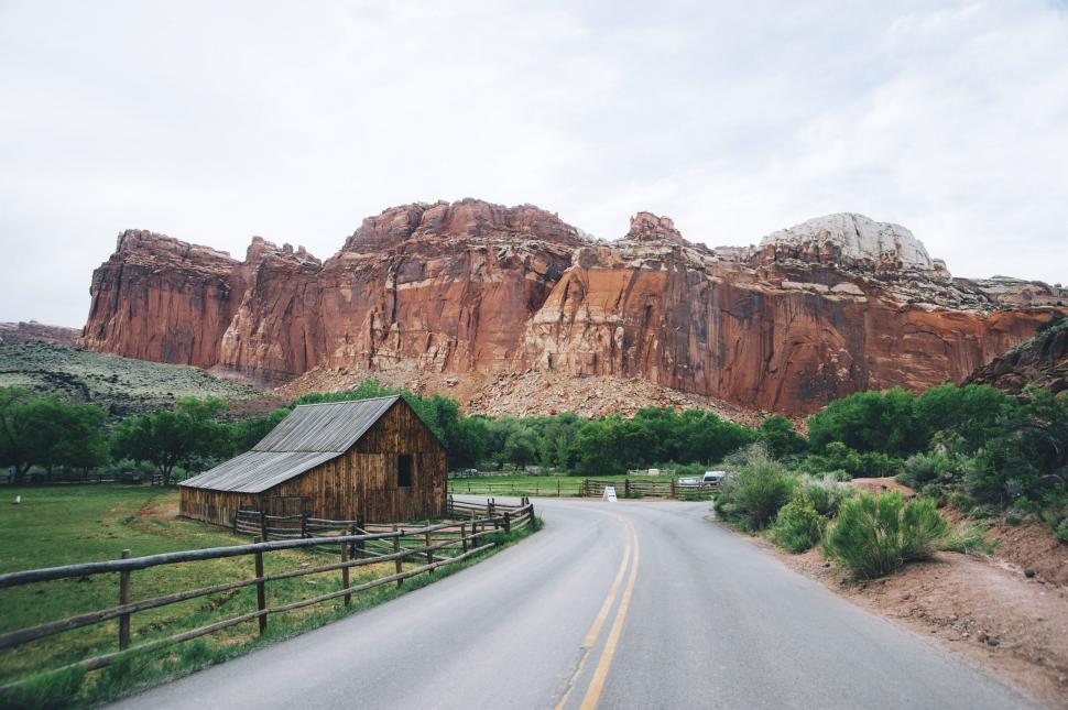 Free Image of Road With Barn and Mountains 