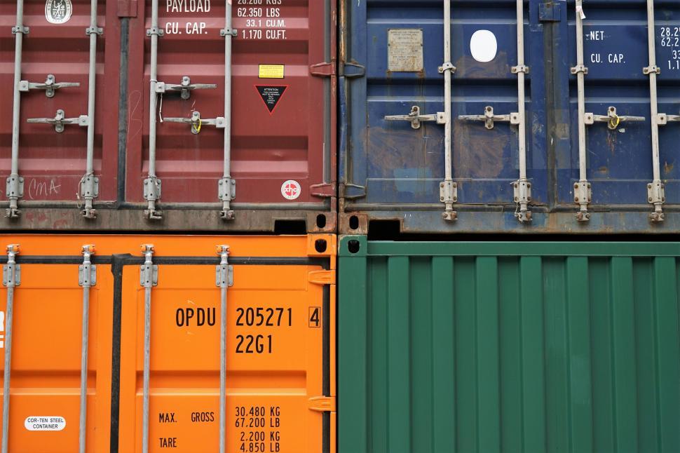Free Image of Stacked Cargo Containers in Industrial Yard 