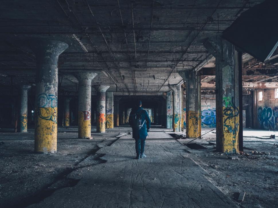 Free Image of Person Walking Through Dark Abandoned Building 