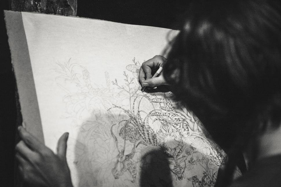 Free Image of Woman Drawing on Piece of Paper 