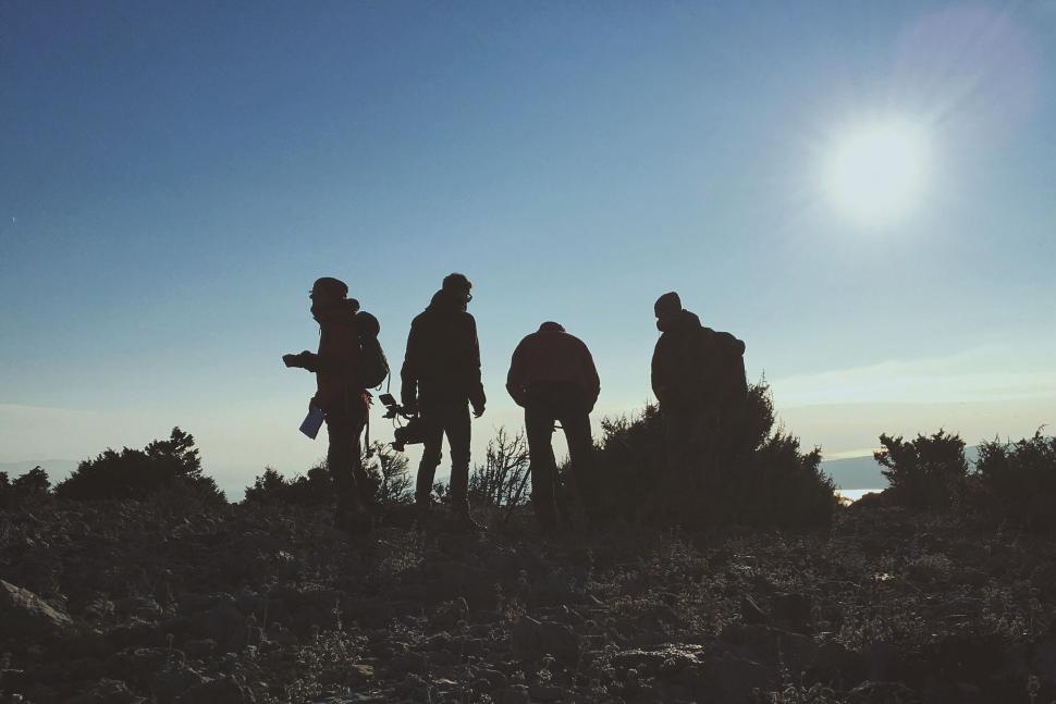 Free Image of Group of People Standing on Top of a Hill 