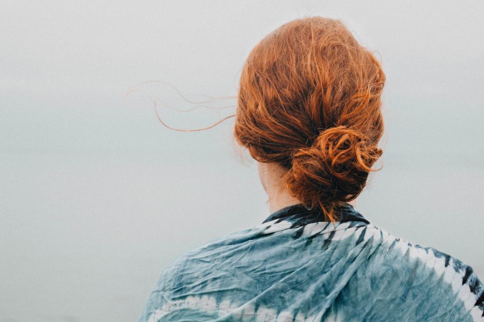 Free Image of Woman With Red Hair Looking Out at Water 