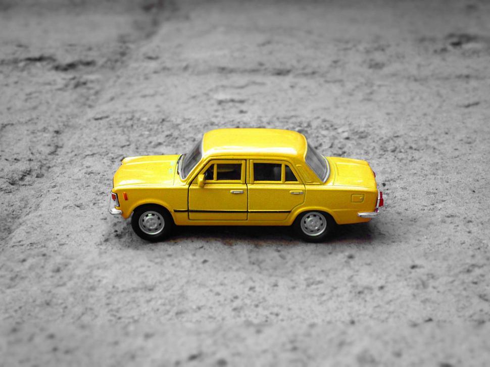 Free Image of Yellow Toy Car in Dirt Field 