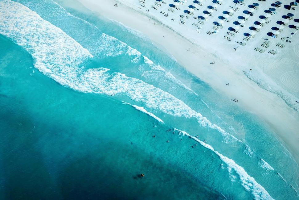 Free Image of Aerial View of Beach With Umbrellas 