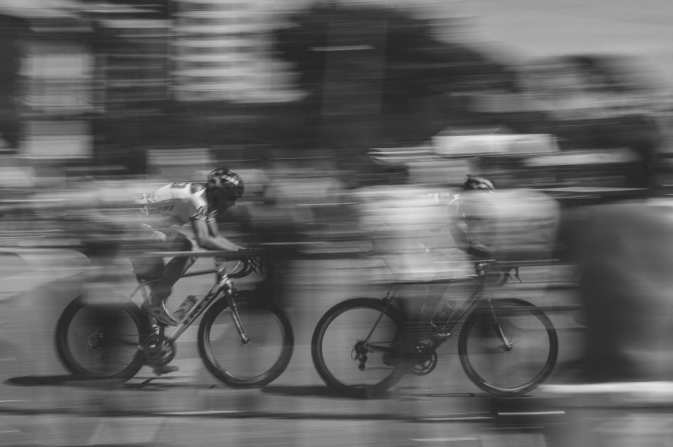 Free Image of Group of People Riding Bikes Down a Street 