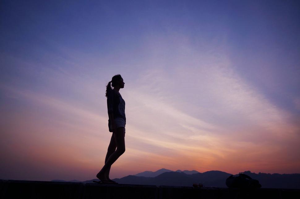 Free Image of Person Standing on Hill With Sky Background 