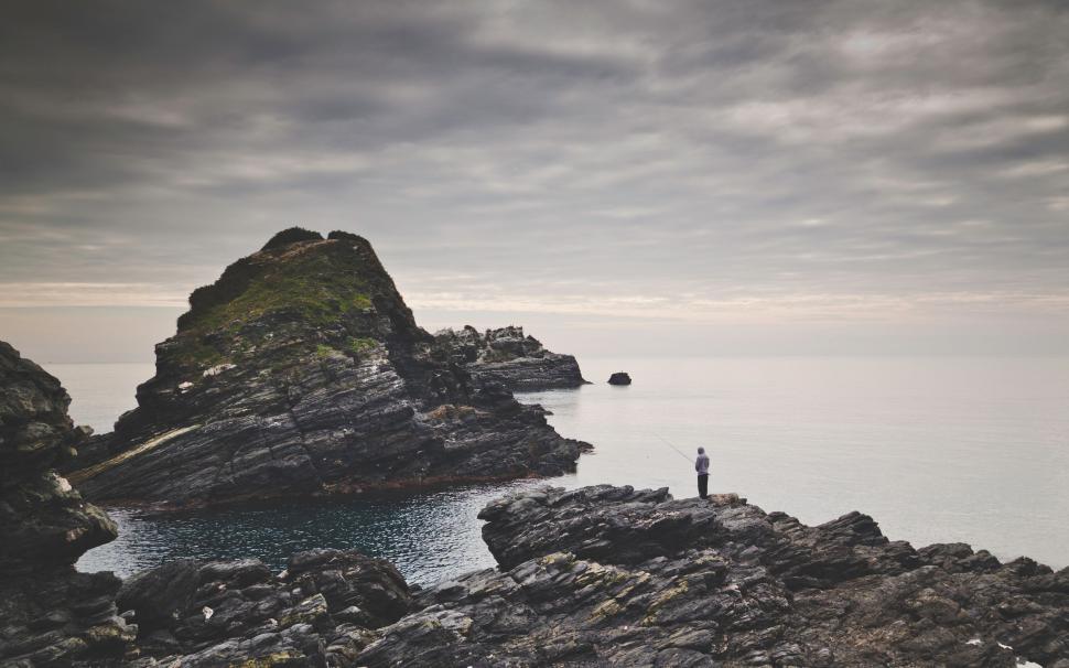 Free Image of Person Standing on Rocky Shore 