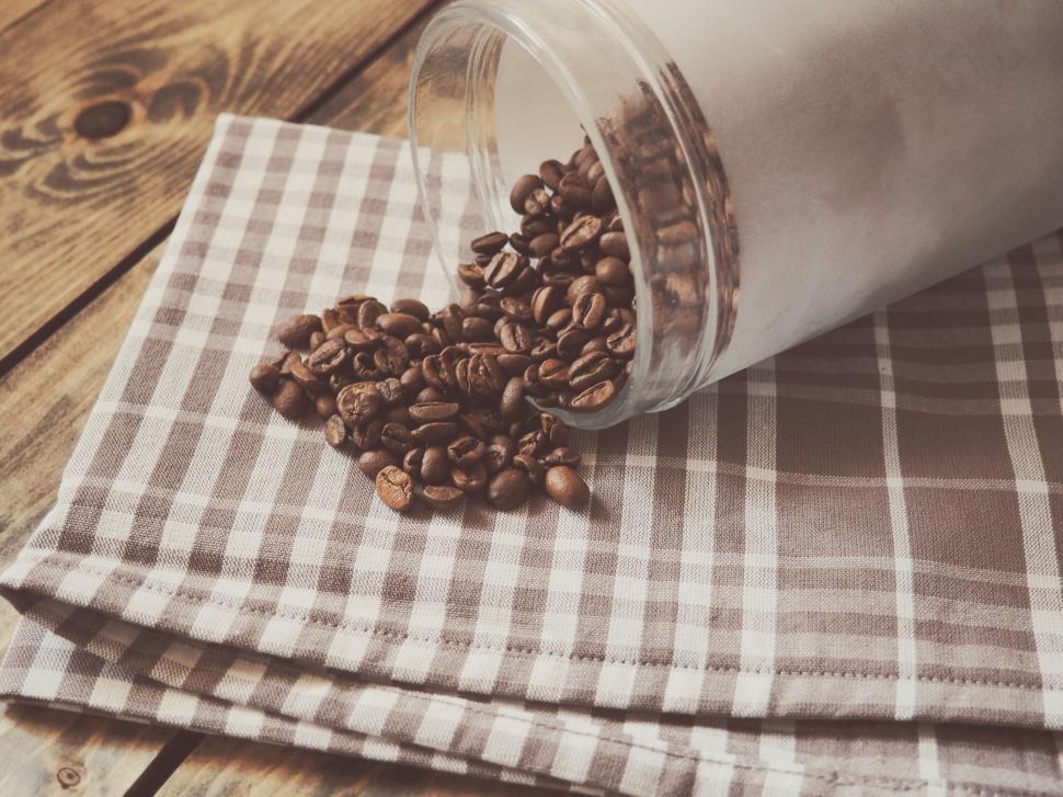 Free Image of Glass Jar Filled With Coffee Beans on Checkered Napkin 
