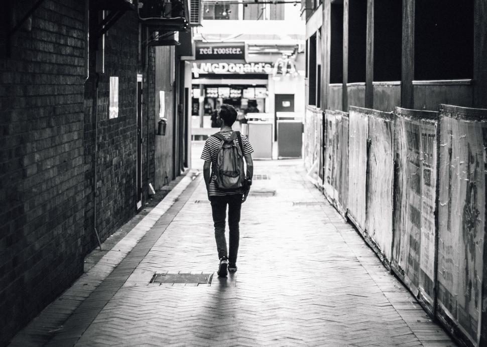 Free Image of Person Walking Down a Narrow Alleyway 