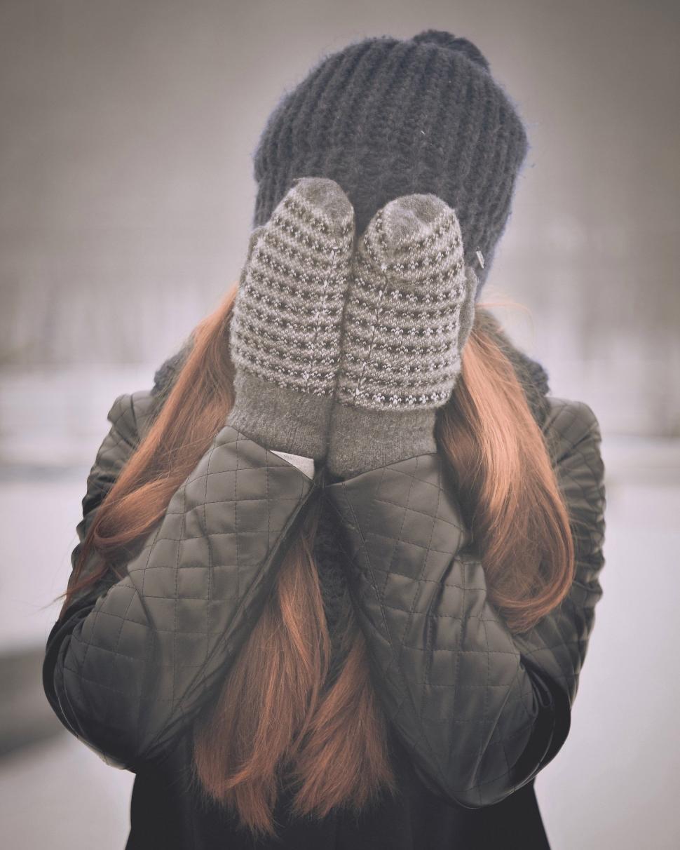 Free Image of Woman Covering Face With Hands 