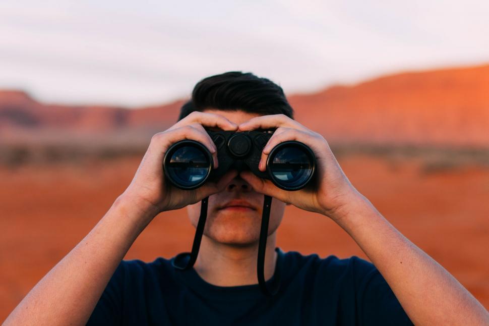 Free Image of Man Looking Through Binoculars in the Desert 