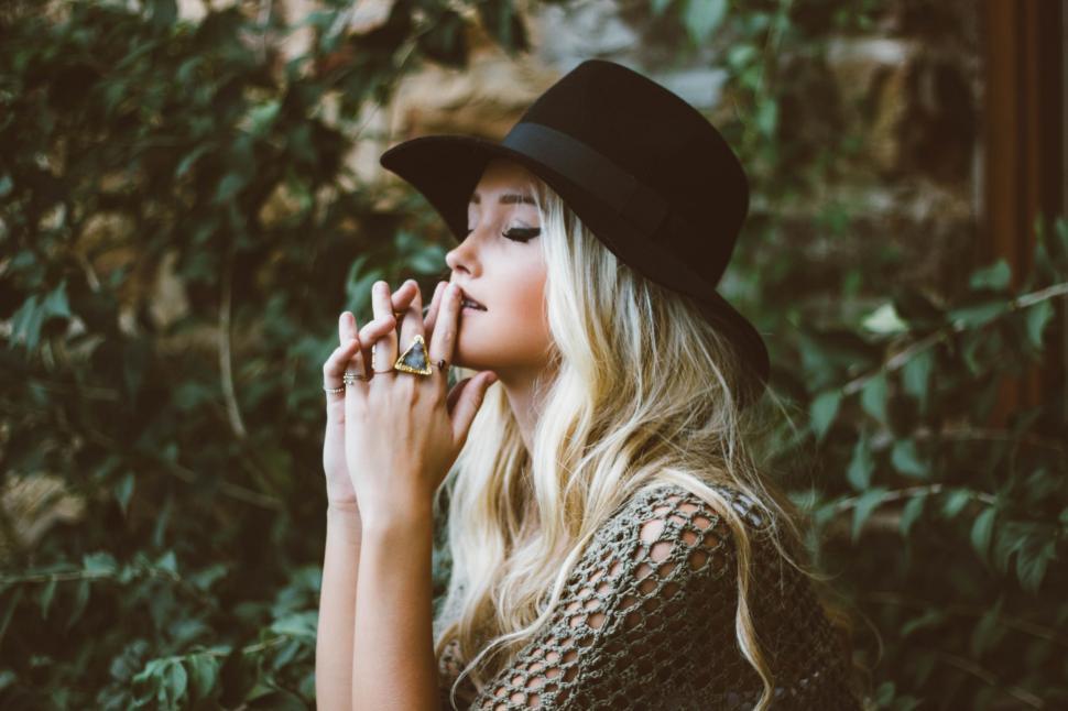 Free Image of Woman Wearing Hat and Smoking a Cigarette 