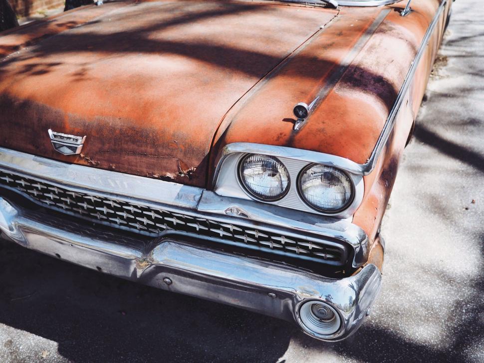 Free Image of Rusted Old Car Parked on Side of Road 
