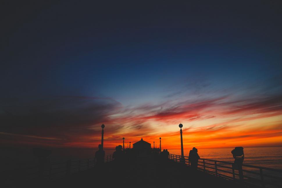 Free Image of Couple Standing on Top of Pier 
