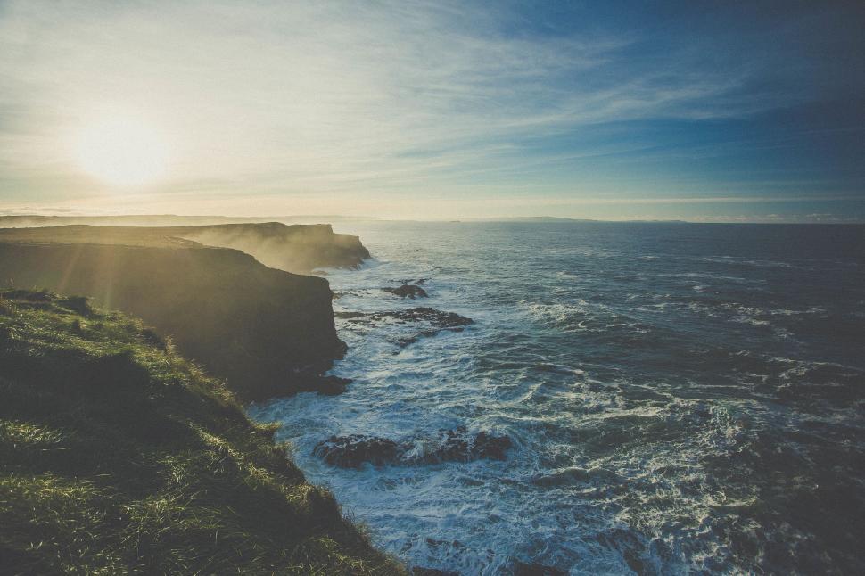 Free Image of Sun Shining Over Ocean and Cliffs 
